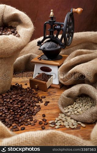 Studio photo of sack with scattered coffee and grinder