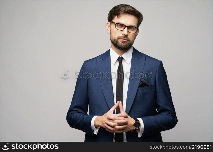 studio photo of young caucasian handsome businessman wearing suit. studio photo of young handsome businessman wearing suit