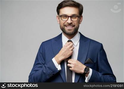 studio photo of young caucasian handsome stylish businessman wearing suit. studio photo of young handsome stylish businessman wearing suit