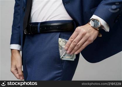 studio photo of young handsome businessman holding US dollar bills. young handsome businessman holding US dollar bills