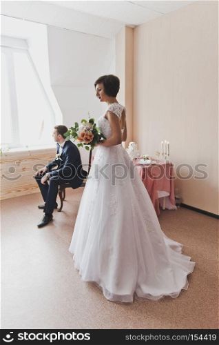 Studio photography of a young family before the ceremony.. Bride in white wedding dress and the groom in a suit 6482.