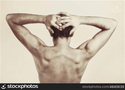 Studio photography of naked back of young man on white background