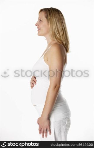 Studio Portrait Of 4 months Pregnant Woman Wearing White