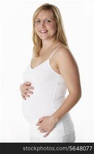 Studio Portrait Of 5 months Pregnant Woman Wearing White