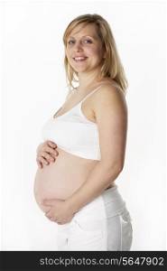 Studio Portrait Of 6 months Pregnant Woman Wearing White