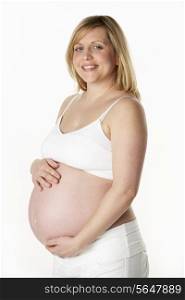 Studio Portrait Of 7 months Pregnant Woman Wearing White