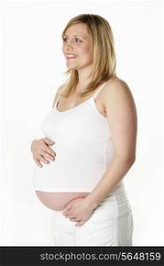 Studio Portrait Of 7 months Pregnant Woman Wearing White