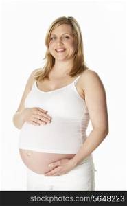 Studio Portrait Of 8 Months Pregnant Woman Wearing White