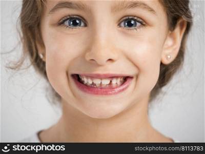 Studio portrait of a beautiful and happy girl smiling