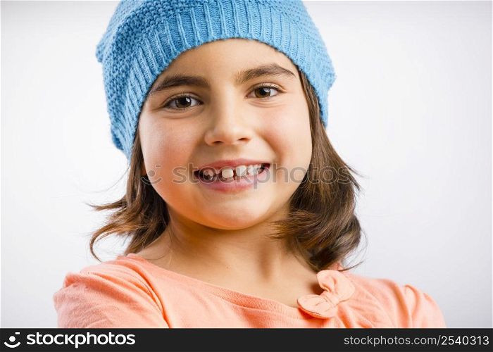 Studio portrait of a beautiful happy girl smilling