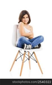Studio portrait of a beautiful young girl sitting on a chair