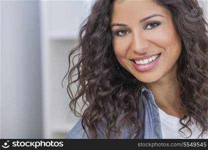Studio portrait of a beautiful young mixed race Latina Hispanic woman smiling