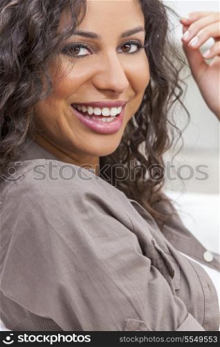 Studio portrait of a beautiful young mixed race Latina Hispanic woman smiling