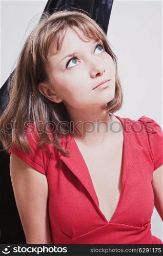 Studio portrait of a beautiful young woman in a red dress