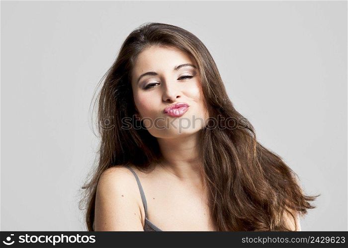 Studio portrait of a beautiful young woman sending a big kiss