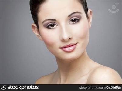 Studio portrait of a beautiful young woman smiling