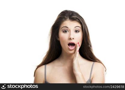 Studio portrait of a beautiful young woman with a astonished expression, isolated on white