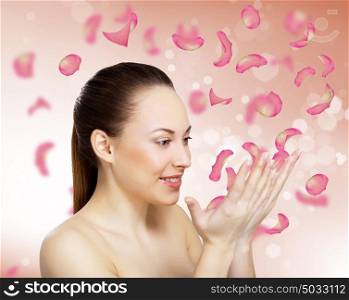 Studio portrait of a beautiful young woman with flowers on background