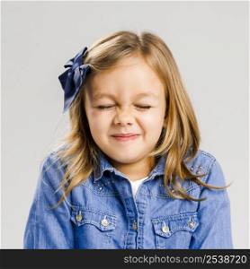 Studio portrait of a cute litle girl with eyes closed