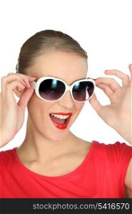 Studio portrait of a fun woman in sunglasses