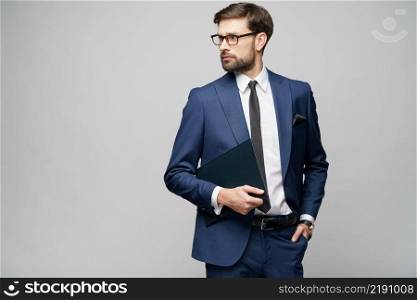 Studio Portrait of a handsome young business man holding document folder. Portrait of a handsome young business man holding document folder