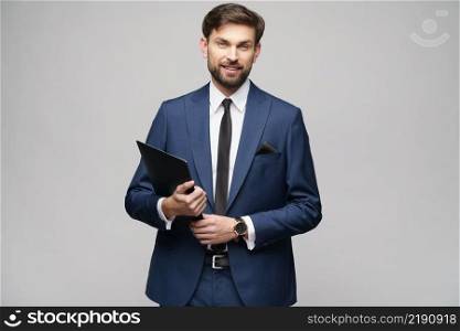Studio Portrait of a handsome young business man holding folder. Portrait of a handsome young business man holding folder
