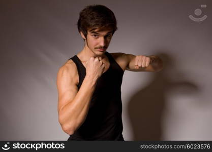 Studio portrait of a handsome young man showing his fists