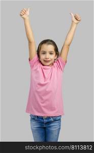 Studio portrait of a happy little girl with arms raised on air