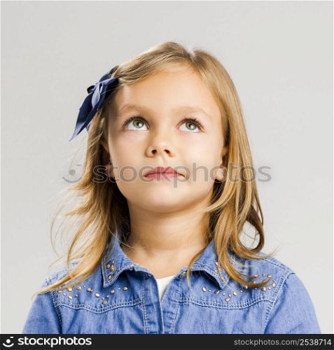 Studio portrait of a little girl thinking