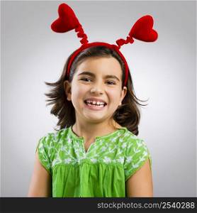Studio portrait of a little girl wearing a headband with hearts