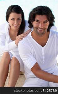 Studio portrait of a relaxed couple on white