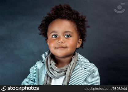 Studio Portrait of a Stylish Little African-American Boy with Curly Hair Isolated on Dark Background. Kids Fashion. Kids Clothes.