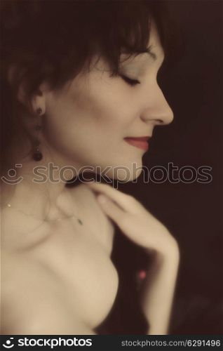 Studio portrait of a young brunette woman closeup