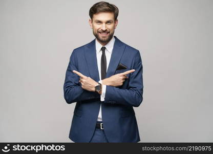 Studio Portrait of a young businessman pointing on a copyspace with his finger. Portrait of a young businessman pointing on a copyspace with his finger