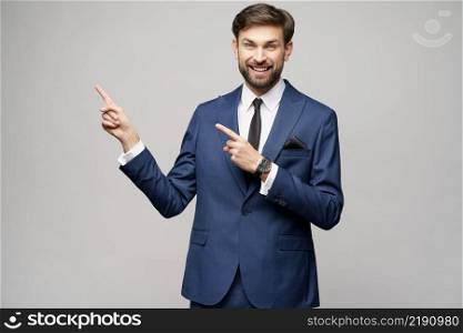 Studio Portrait of a young businessman pointing on a copyspace with his finger. Portrait of a young businessman pointing on a copyspace with his finger