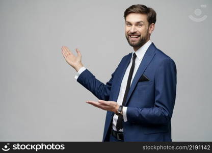 Studio Portrait of a young businessman pointing on a copyspace with his finger. Portrait of a young businessman pointing on a copyspace with his finger