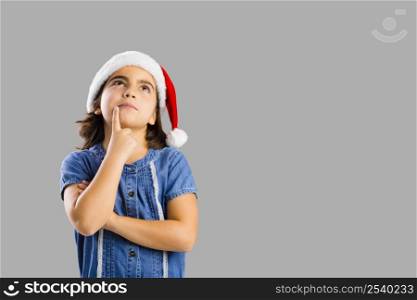 Studio portrait of a young girl thinking about Christmas