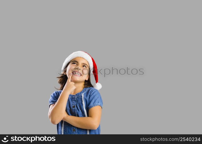 Studio portrait of a young girl thinking about Christmas