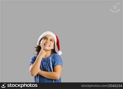 Studio portrait of a young girl thinking about Christmas