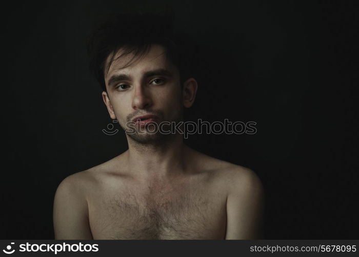 Studio portrait of a young handsome man on a black background