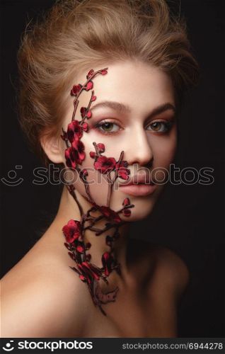 Studio Portrait of a young woman with flower makeup. Young woman with flower makeup