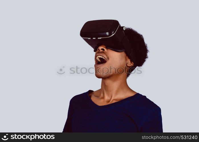 Studio portrait of afro american man with VR headset is looking at interactive screen. Man experiencing virtual reality.
