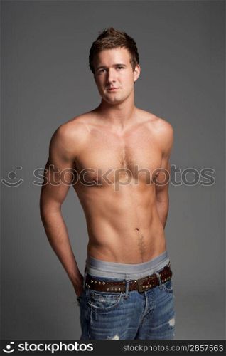 Studio Portrait Of Bare Chested Muscular Young Man