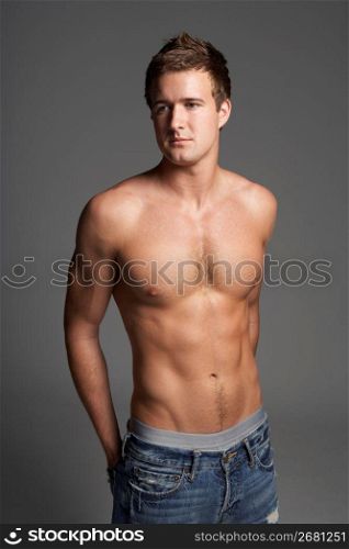 Studio Portrait Of Bare Chested Muscular Young Man