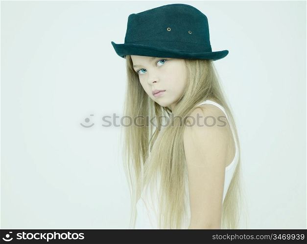 Studio portrait of beautiful little girl in hat