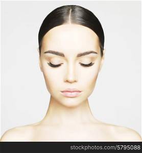 Studio portrait of beautiful young woman with perfect skin. Beauty and care. Extension eyelashes. Spa salon