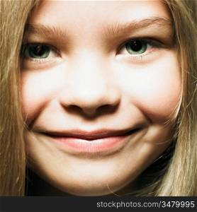 Studio portrait of charming smiling little girl