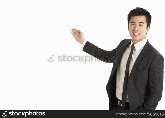 Studio Portrait Of Chinese Businessman Gesturing