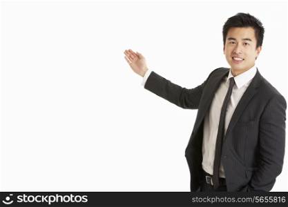 Studio Portrait Of Chinese Businessman Gesturing