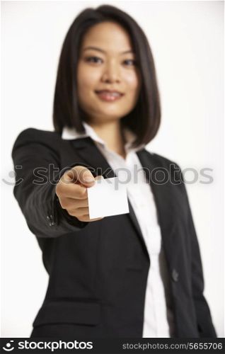 Studio Portrait Of Chinese Businesswoman Offering Business Card